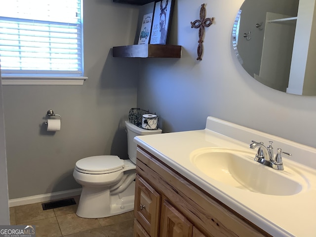 bathroom featuring baseboards, visible vents, toilet, tile patterned floors, and vanity