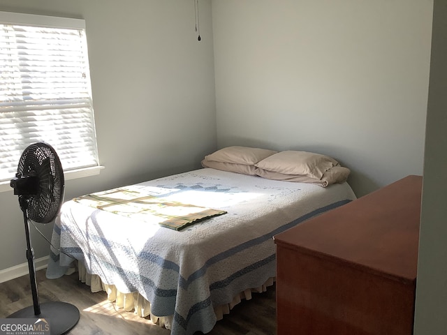 bedroom featuring multiple windows and wood finished floors