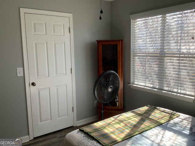 bedroom featuring dark wood-type flooring and baseboards