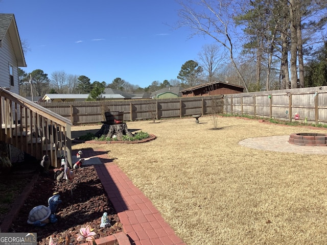 view of yard with an outdoor fire pit and a fenced backyard