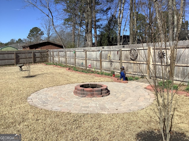 view of yard with an outdoor fire pit, a patio area, and a fenced backyard