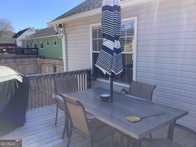 wooden terrace featuring fence and outdoor dining area