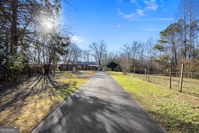 view of street featuring driveway and a rural view