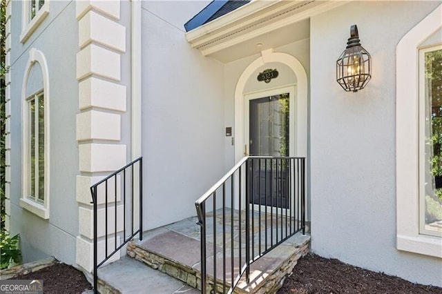 view of exterior entry featuring stucco siding