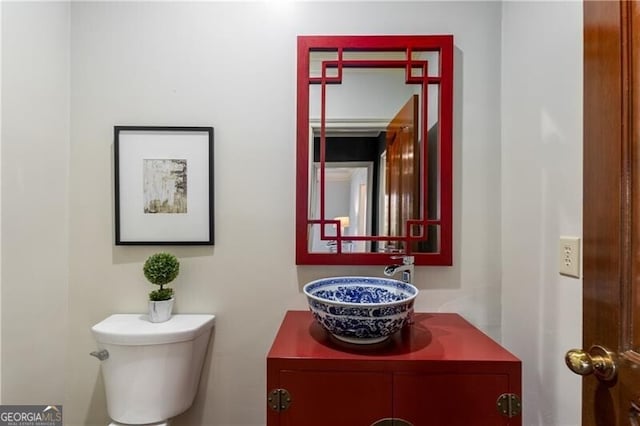 half bathroom with toilet and vanity