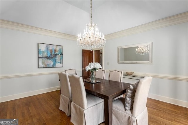 dining space with crown molding, baseboards, and wood finished floors