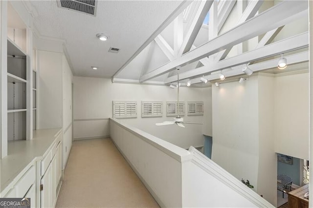 interior space featuring ceiling fan and visible vents