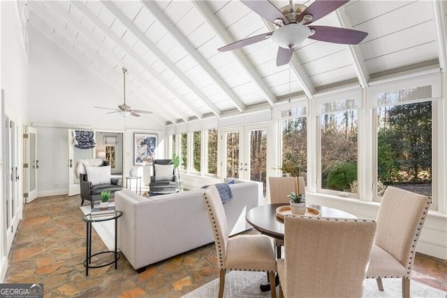 sunroom featuring lofted ceiling with beams, ceiling fan, and french doors