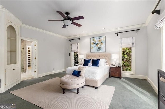 carpeted bedroom with baseboards, ceiling fan, and crown molding