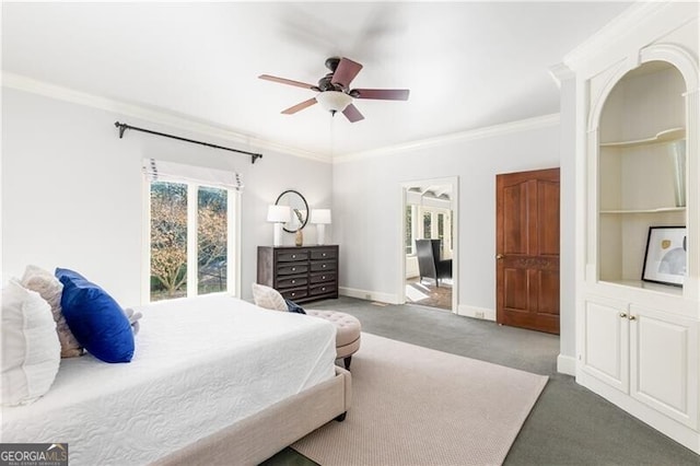 carpeted bedroom featuring baseboards, ornamental molding, and ceiling fan