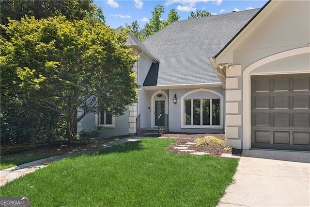 view of front of home featuring roof with shingles, stucco siding, concrete driveway, a garage, and a front lawn