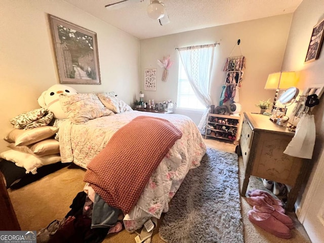 bedroom with a textured ceiling, ceiling fan, and carpet flooring