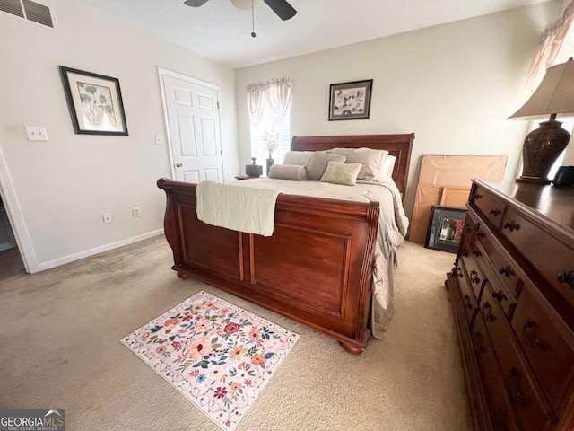 bedroom featuring light carpet, baseboards, visible vents, and a ceiling fan