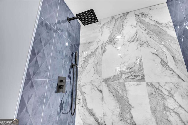 details featuring a marble finish shower