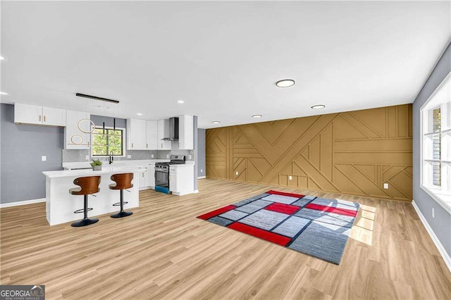 interior space featuring light wood-style floors, baseboards, and recessed lighting