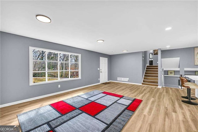 exercise area with recessed lighting, wood finished floors, visible vents, and baseboards