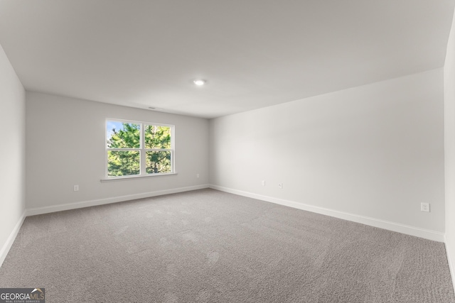 carpeted empty room with baseboards