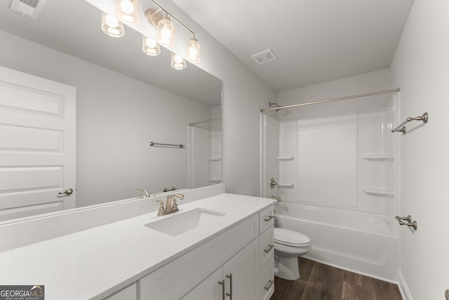 bathroom featuring toilet, visible vents, wood finished floors, and vanity