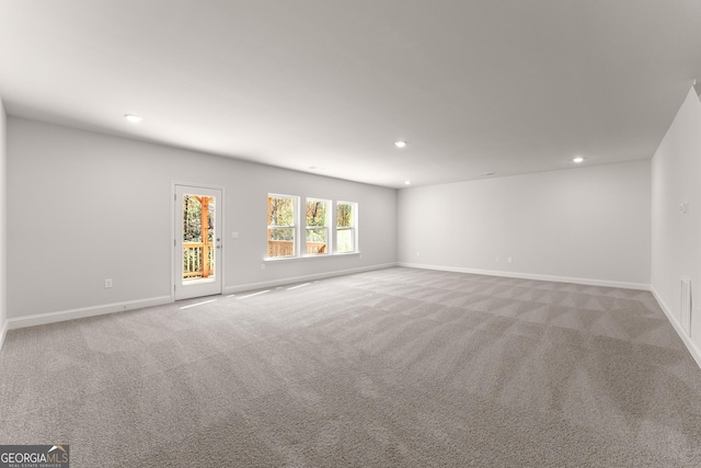 carpeted spare room featuring baseboards and recessed lighting