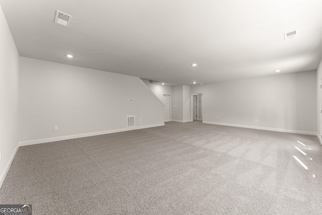 unfurnished living room with recessed lighting, visible vents, and baseboards