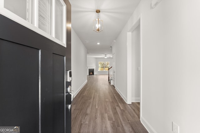 hall featuring baseboards and wood finished floors