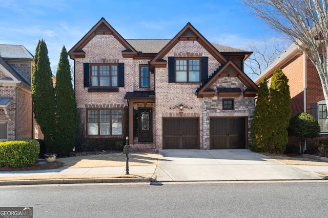 view of front facade featuring driveway, brick siding, an attached garage, and stone siding