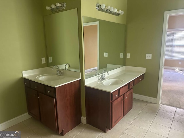 bathroom with two vanities, a sink, and tile patterned floors