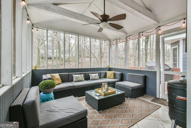 sunroom / solarium featuring vaulted ceiling with beams and a ceiling fan