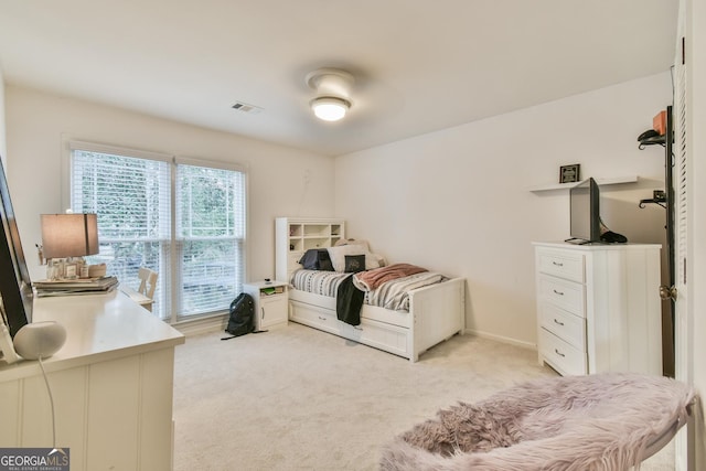 bedroom with light carpet, visible vents, and baseboards