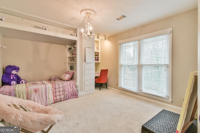 carpeted bedroom featuring an inviting chandelier, visible vents, and baseboards