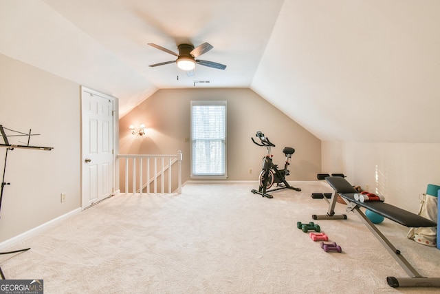 workout room with vaulted ceiling, carpet flooring, visible vents, and baseboards