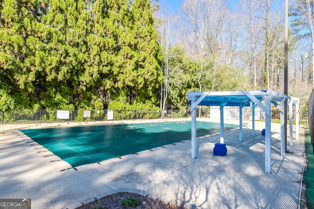 pool with a patio, fence, and a pergola