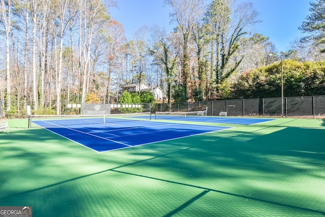 view of sport court featuring fence