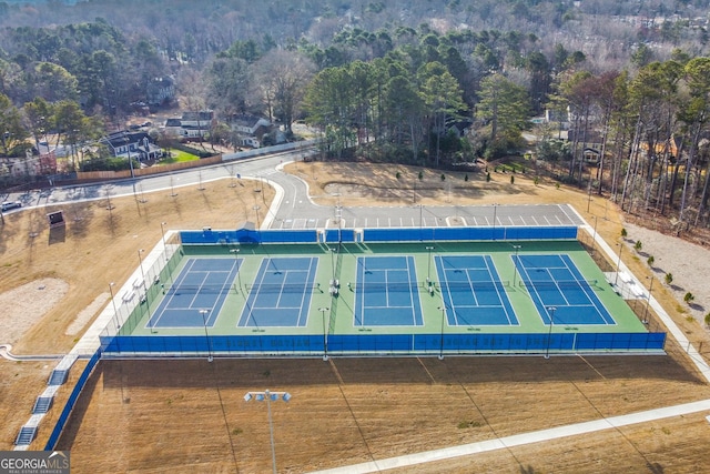 birds eye view of property featuring a view of trees