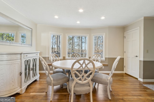 dining area featuring plenty of natural light, light wood-style flooring, and crown molding