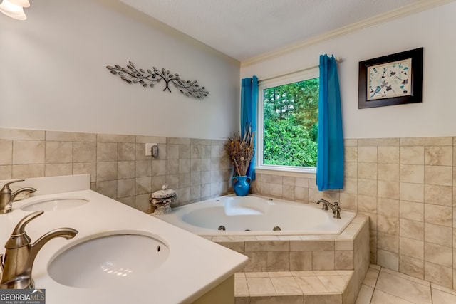 bathroom featuring a whirlpool tub, tile patterned flooring, a sink, and tile walls