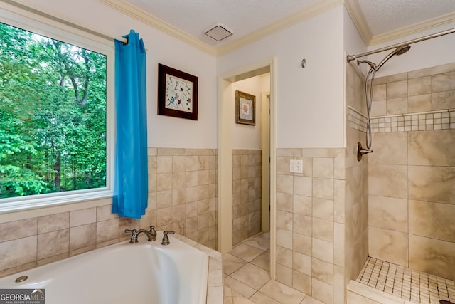 full bath featuring a textured ceiling and tiled shower