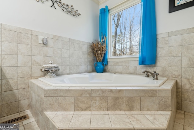 full bathroom featuring a garden tub, visible vents, and tile patterned floors