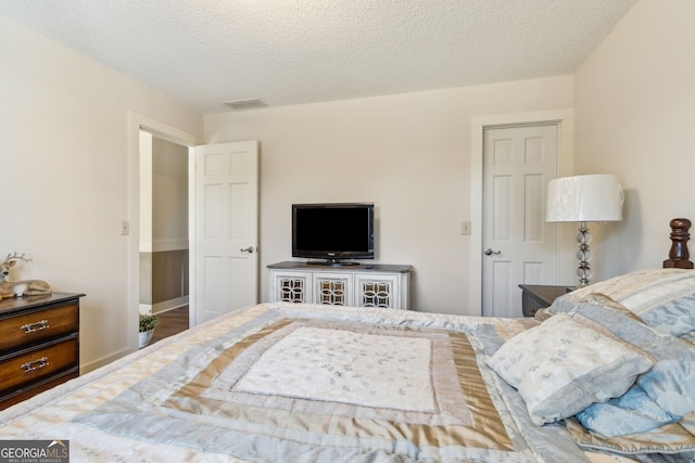 bedroom with visible vents and a textured ceiling