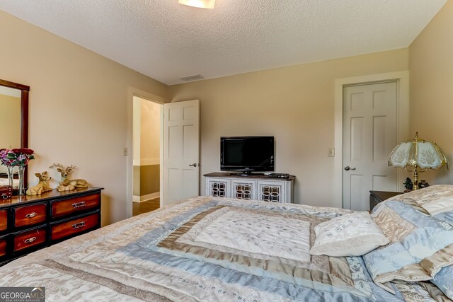 bedroom featuring visible vents and a textured ceiling