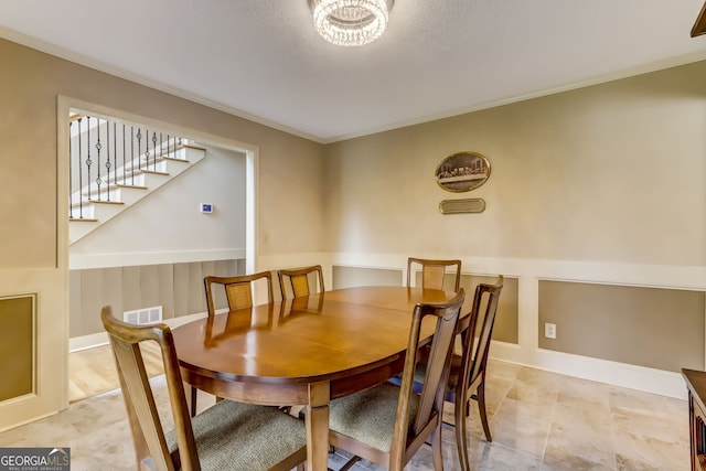 dining space featuring stairs, visible vents, and baseboards