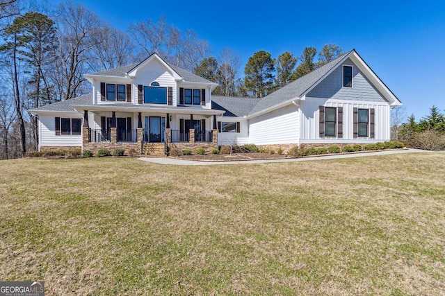 view of front of property with covered porch, board and batten siding, and a front yard