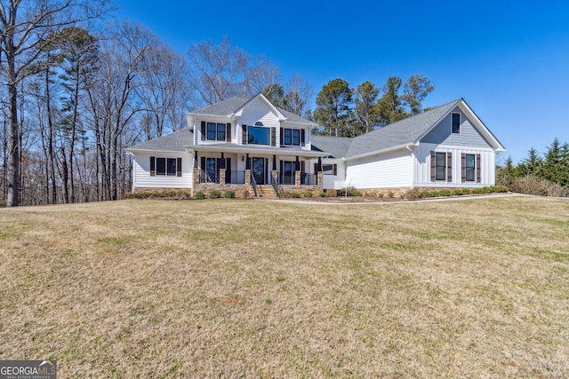 view of front of property featuring covered porch and a front lawn