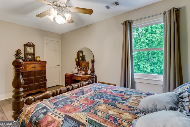 bedroom with ceiling fan, visible vents, and baseboards