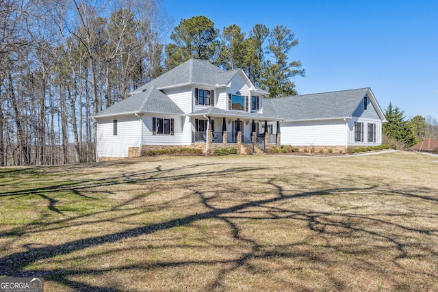 view of front of home featuring covered porch and a front yard