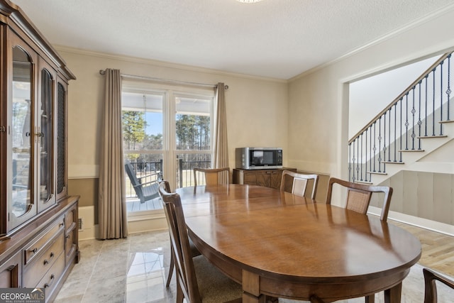 dining room with stairway, baseboards, ornamental molding, and a textured ceiling