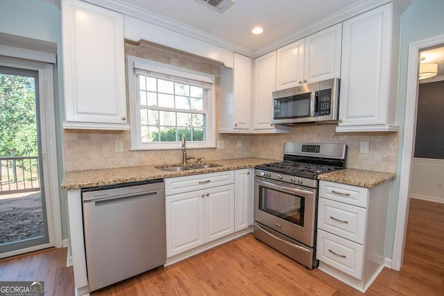 kitchen with white cabinets, stainless steel appliances, and a sink