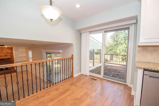 interior space featuring recessed lighting, baseboards, visible vents, and light wood finished floors