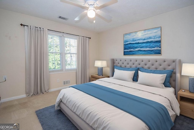 bedroom featuring carpet floors, baseboards, visible vents, and ceiling fan