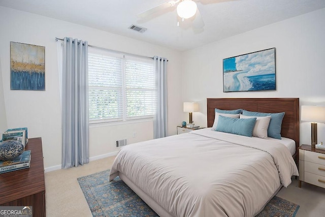 bedroom featuring baseboards, ceiling fan, visible vents, and light colored carpet